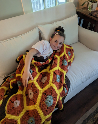 Maple cuddling in a cozy blanket