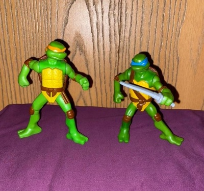 Two green ninja turtle toys