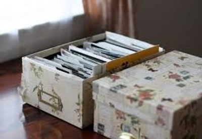the box of photos is filled of pictures.