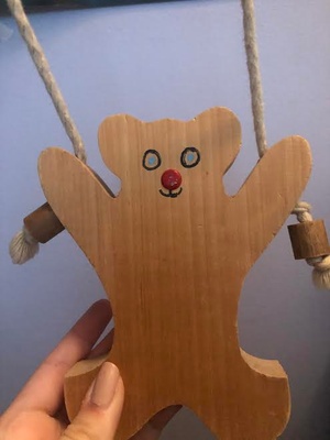Its a wooden bear with strings.
