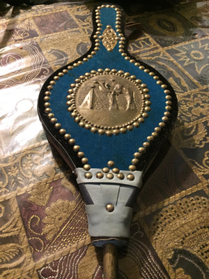A Moroccan bellow with decorations engraved into the metal.