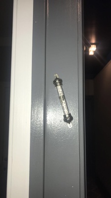 This is a Mezuzah. It is a scroll with a jewish prayer written on it put into a case and then hung in the door way.