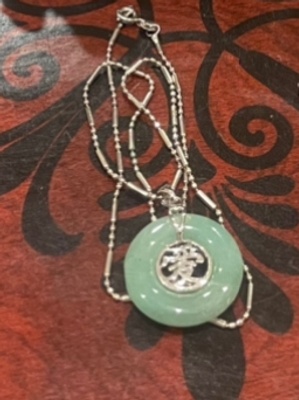 Jade necklace: symbolizes familial ties