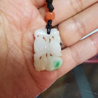 The jade pendant of the necklace.