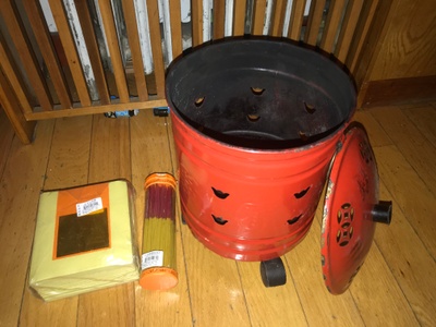This is a joss paper burner/red can, joss paper/yellow pack, & incense sticks/cylinder.