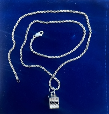 Silver necklace with a Kaaba pendant.