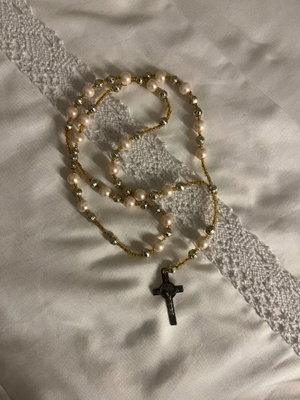 A beaded Rosary with a cross at the end