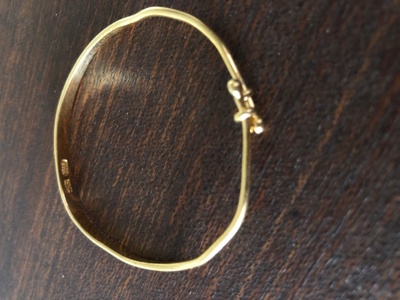 The gold baby bracelet is small