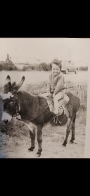 My mom riding a donkey at a caravan park. 1967