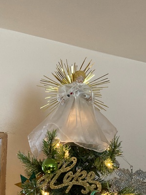 It is a tree topper and is a angel 