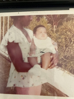 Grandmother holding infant mother 