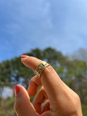 Gold ring with elephants adorning it.