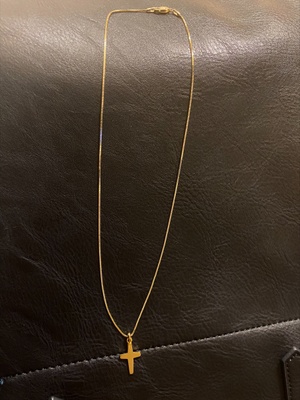 A smooth golden chain with a gold cross.