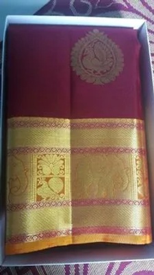 This is a red and gold saree made of silk, generally worn to formal events.