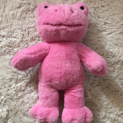 A fuzzy pink frog stuffed animal