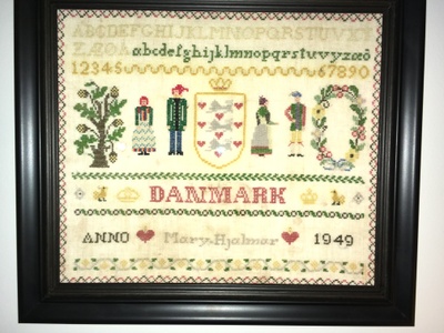Needlework with the "Danmark" in center, danish alphabet and coat of arms also pictured