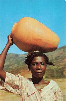 Haitian mother holding a jug of water