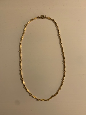 A necklace of interlinked gold chains.