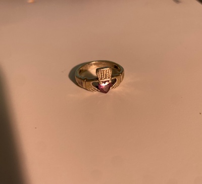 A Silver Claddagh Ring with a Purple Gem