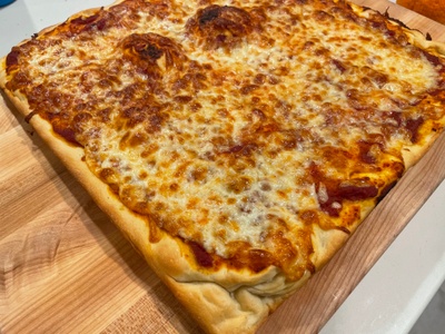 Square pizza on a wooden cutting board