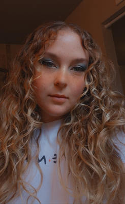 Me with curly hair and blue eyeshadow