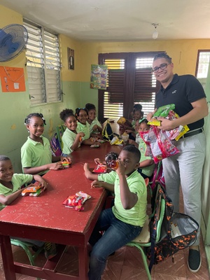 Edward donating to children in the DR