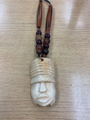 Bone carved face with wooden beads