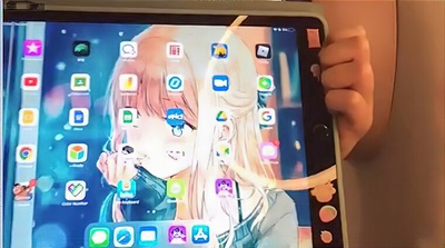 an iPad screen with anime background