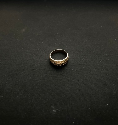Golden ring with a carved design