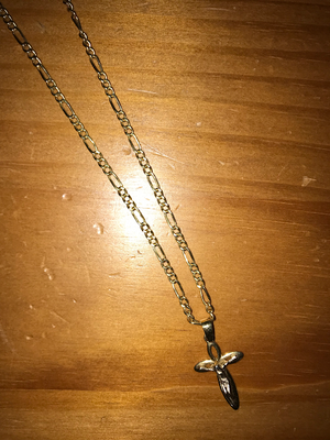 This is a golden cross necklace. It is made from 18 karat Italian gold and purchased in Italy.