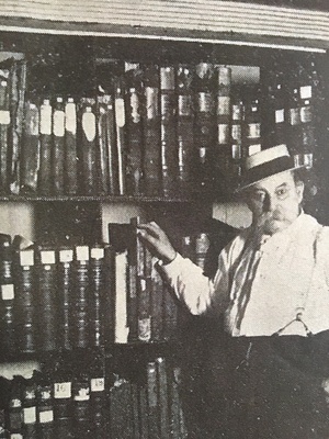 Archivist standing in front of the record books