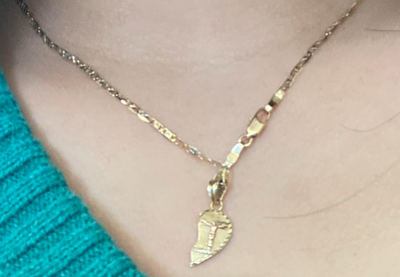 Necklace of a cross on a half heart