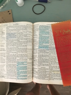 A page in the bible with many notes and highlights
