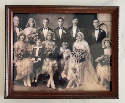 A photograph of 12 people at a wedding