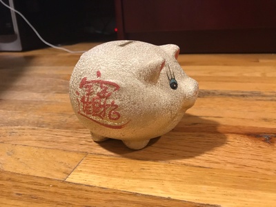 A stylized golden piggy bank