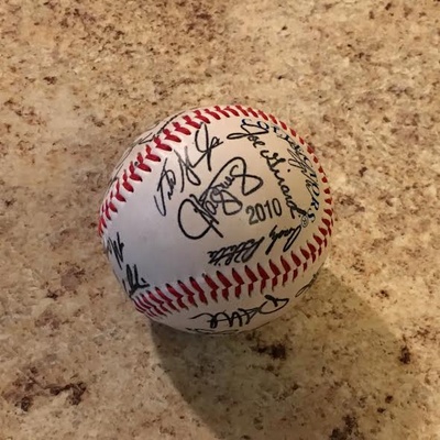 A fake baseball with many professional players signatures.