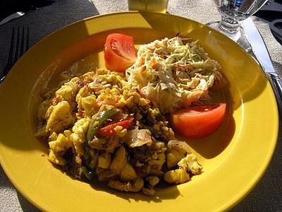 Plate of ackee and salt fish with tomatoes and salad. Retrieved from Wikipedia .