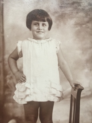 Sylvia, 3, wears a dress her mother made