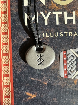 Grey stone on black chain, black symbol- close up